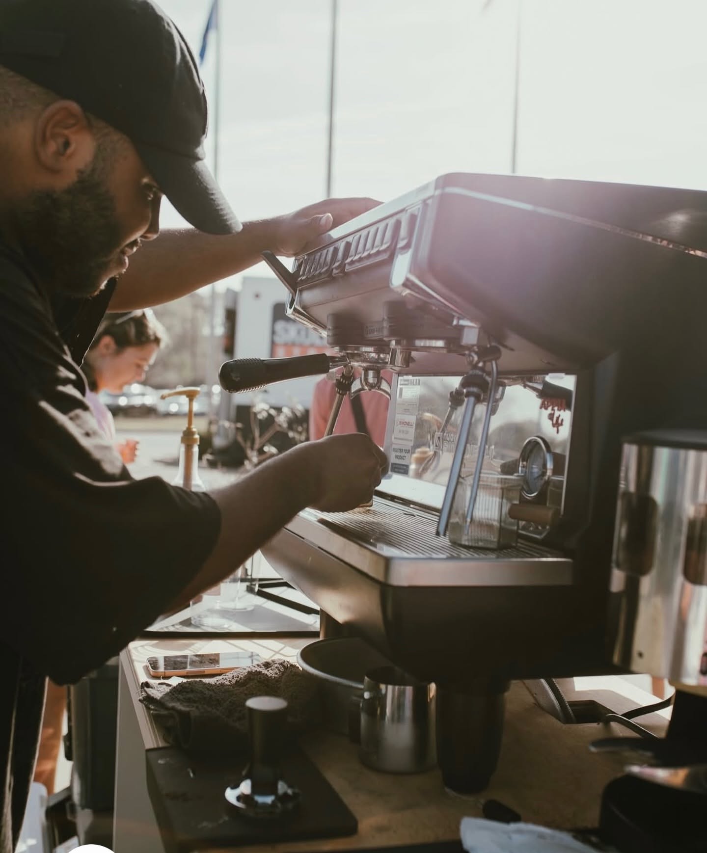 A barista pulling espresso shots on the mobile cart