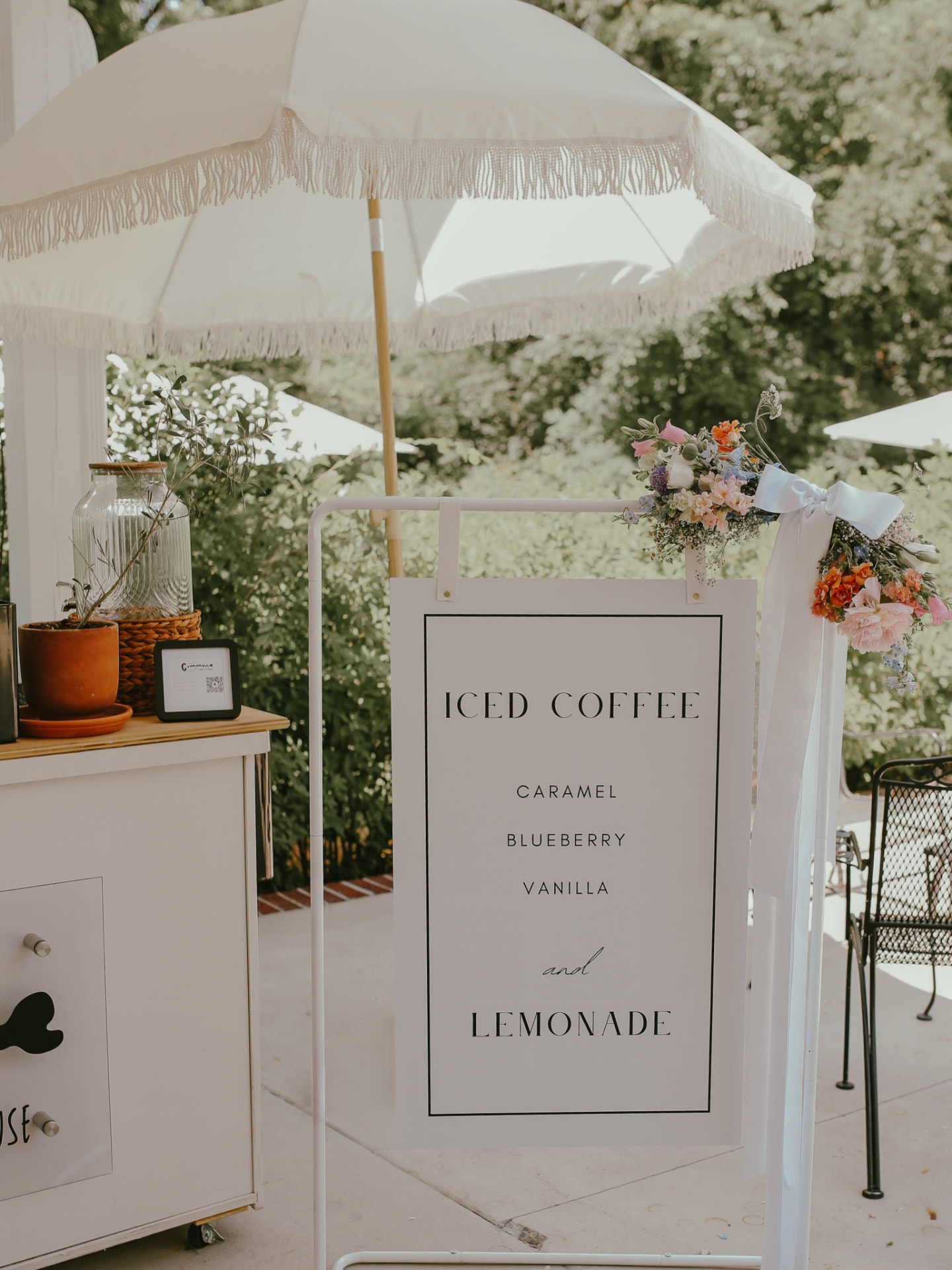 A minimal menu sign listing iced coffee flavors and lemonade
